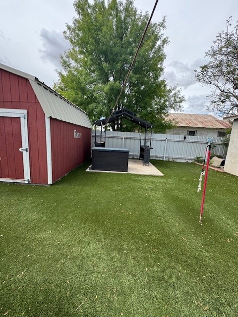 906 W 5th St, Fort Stockton, TX 79735 - fenced backyard with a hot tub, a storage unit, and a patio area