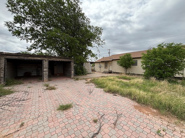 exterior space featuring a garage and an outbuilding
