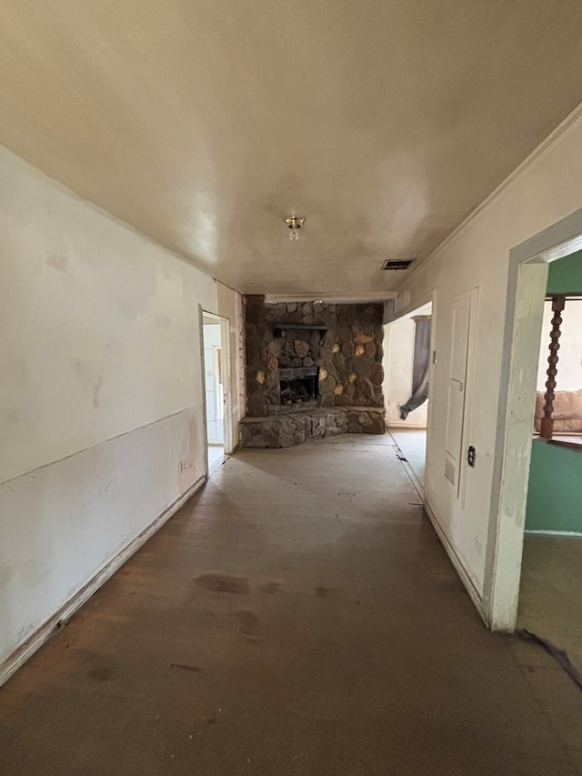 unfurnished living room with a stone fireplace
