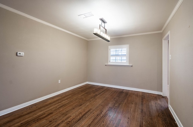 empty room with ornamental molding and dark wood-type flooring