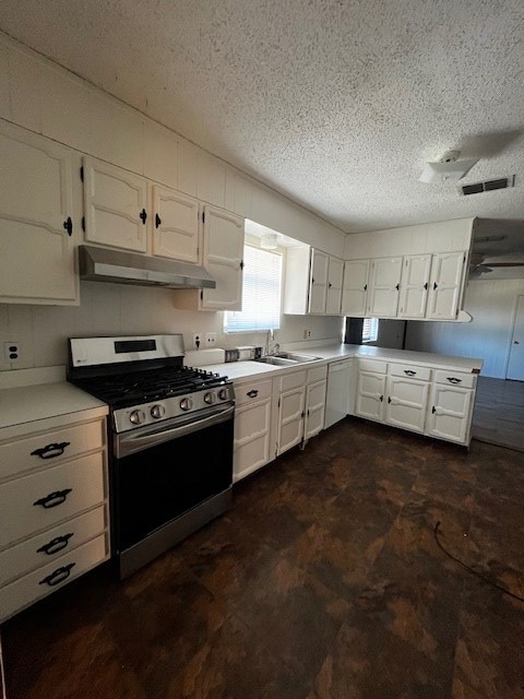 kitchen with sink, white cabinetry, a textured ceiling, and stainless steel gas range oven