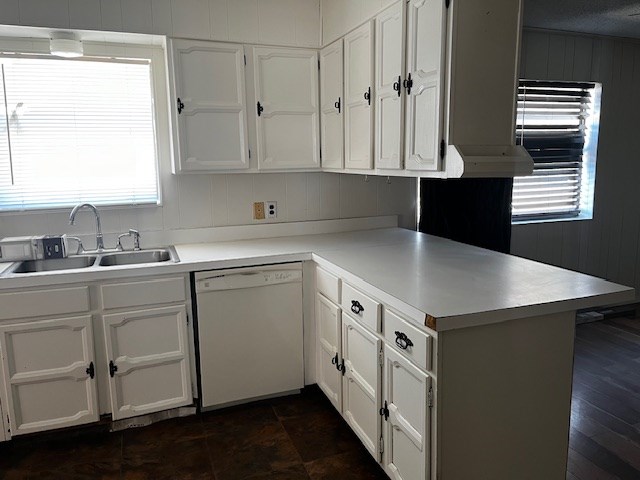 kitchen featuring sink, white cabinetry, dishwasher, and kitchen peninsula