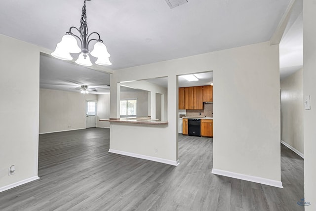 3404 W Michigan Ave, Midland, TX 79703 - kitchen with black dishwasher, brown cabinets, wood finished floors, a chandelier, and a ceiling fan