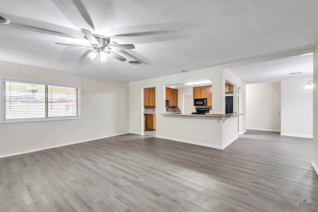 3404 W Michigan Ave, Midland, TX 79703 - unfurnished living room with ceiling fan, wood finished floors, and baseboards