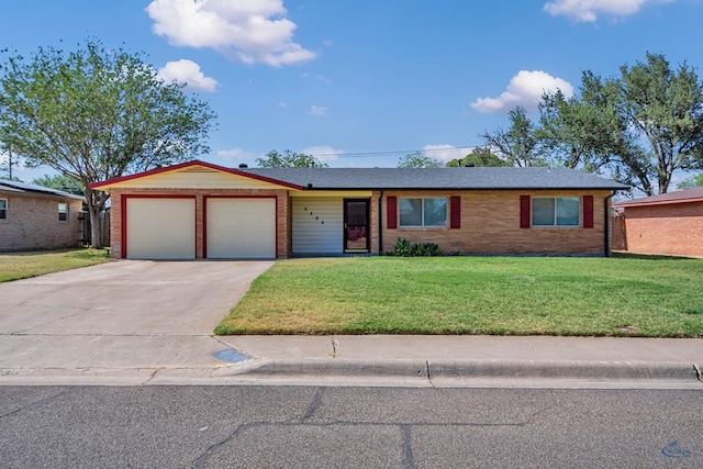 3404 W Michigan Ave, Midland, TX 79703 - ranch-style home with an attached garage, a front lawn, concrete driveway, and brick siding