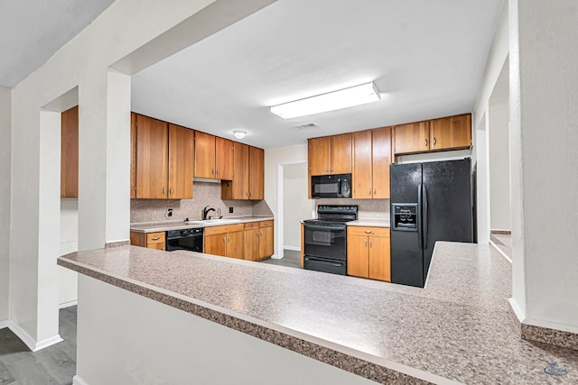 3404 W Michigan Ave, Midland, TX 79703 - kitchen with black appliances, baseboards, tasteful backsplash, a sink, and light countertops