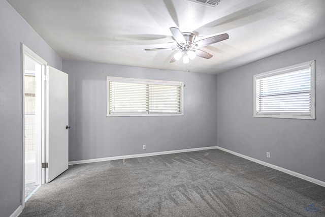 3404 W Michigan Ave, Midland, TX 79703 - unfurnished bedroom with carpet floors, multiple windows, baseboards, and ceiling fan