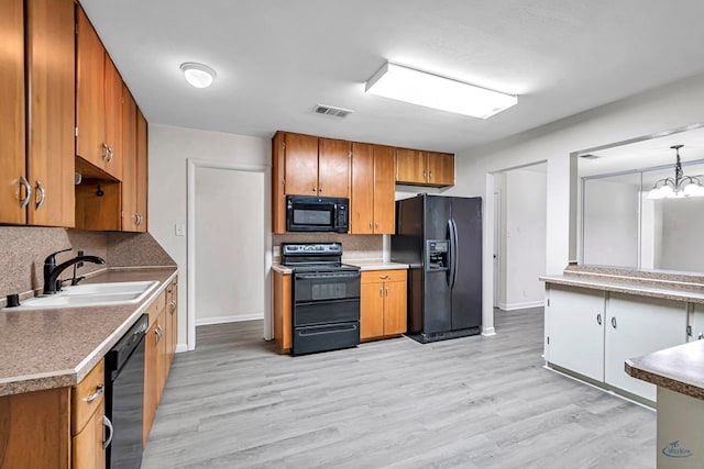 3404 W Michigan Ave, Midland, TX 79703 - kitchen featuring black appliances, a sink, and brown cabinetry