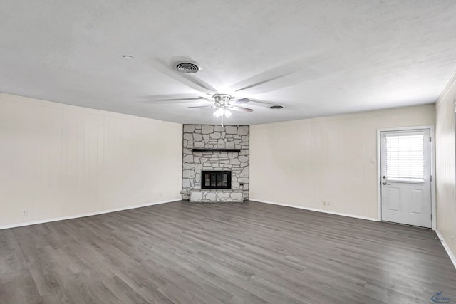 3404 W Michigan Ave, Midland, TX 79703 - unfurnished living room with wood finished floors, ceiling fan, a stone fireplace, and baseboards