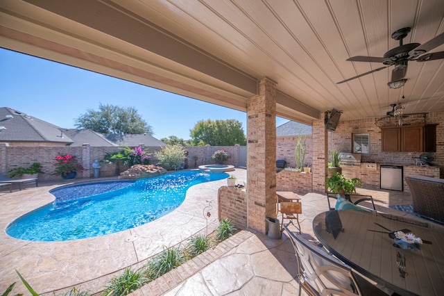 view of pool featuring ceiling fan, area for grilling, exterior kitchen, and a patio