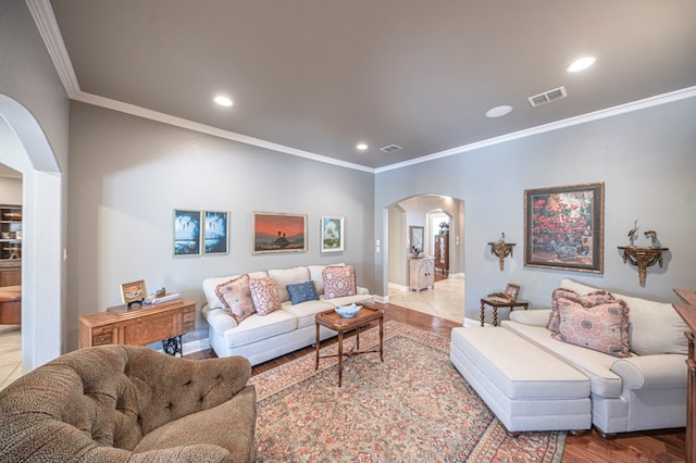 living room featuring crown molding and light wood-type flooring