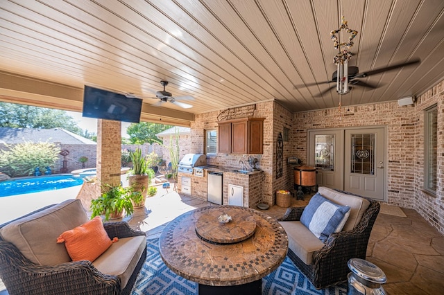 view of patio featuring area for grilling, ceiling fan, sink, a fenced in pool, and a grill