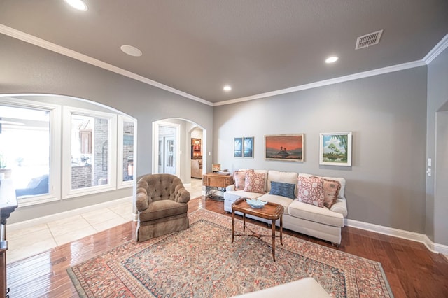 living room with wood-type flooring and ornamental molding