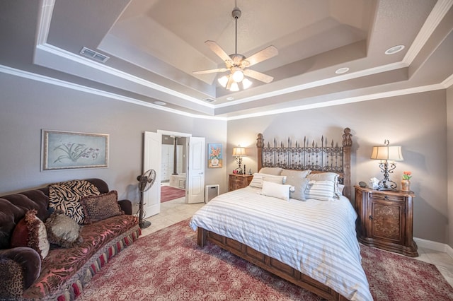 bedroom featuring ceiling fan, ornamental molding, light tile patterned floors, and a tray ceiling