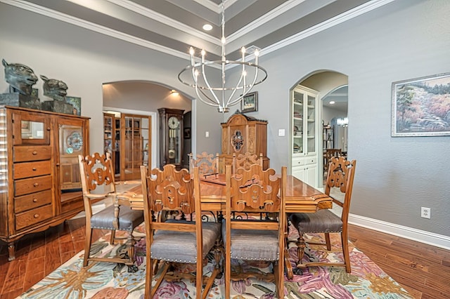 dining space featuring crown molding, a chandelier, and wood-type flooring