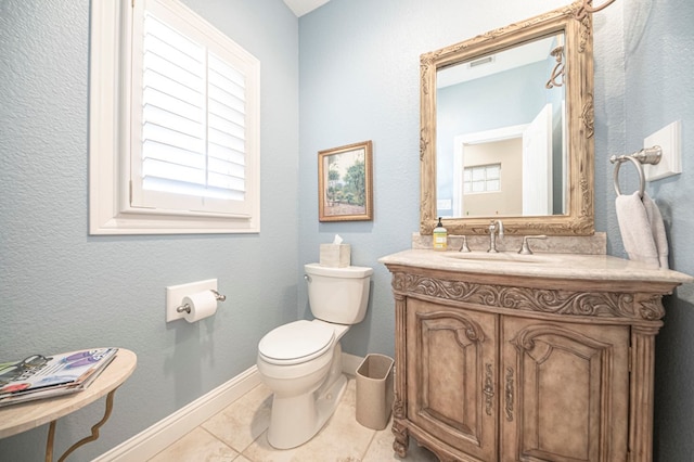 bathroom featuring tile patterned floors, vanity, and toilet