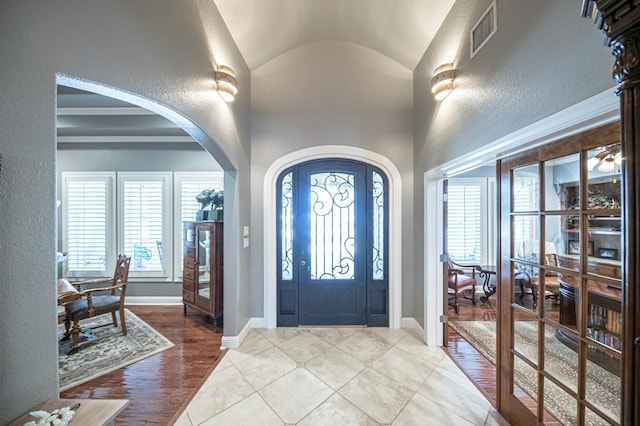 entrance foyer featuring wood-type flooring and lofted ceiling