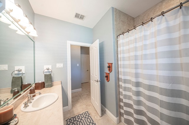 bathroom with tile patterned floors and vanity