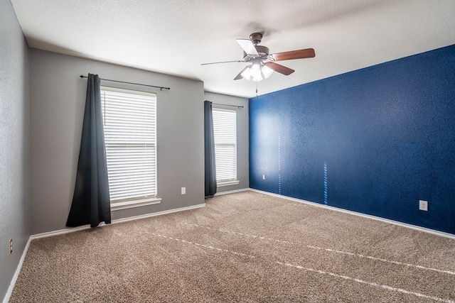 carpeted empty room with ceiling fan