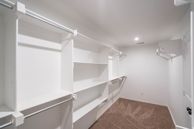 spacious closet featuring dark carpet