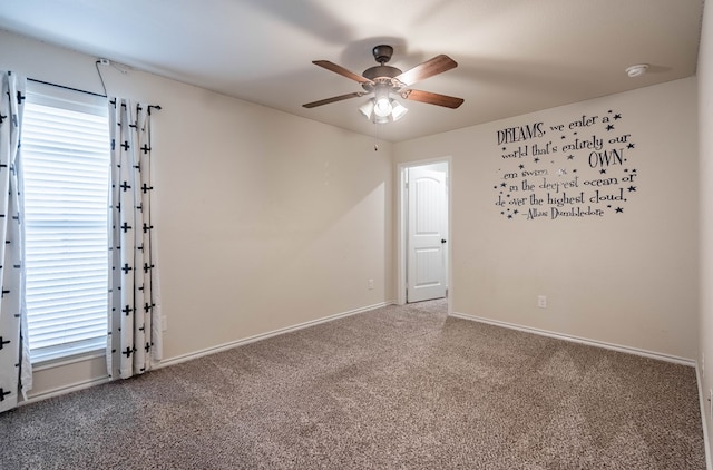 carpeted spare room with ceiling fan