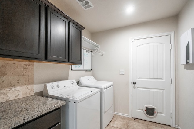 washroom featuring cabinets and washer and dryer