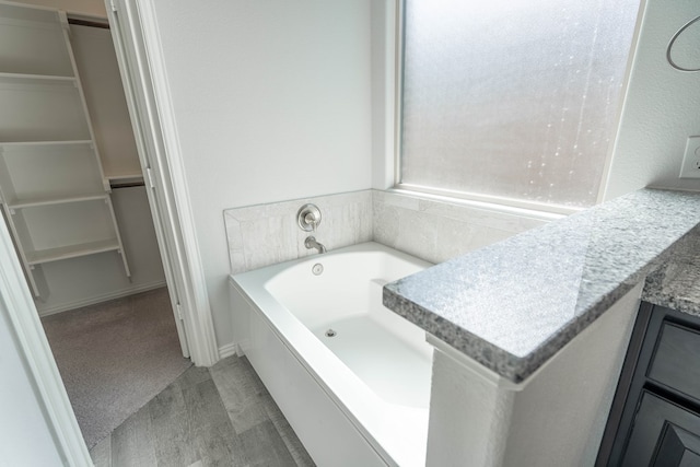 1212 Santa Clara, Midland, TX 79705 - bathroom with a bath and a spacious closet