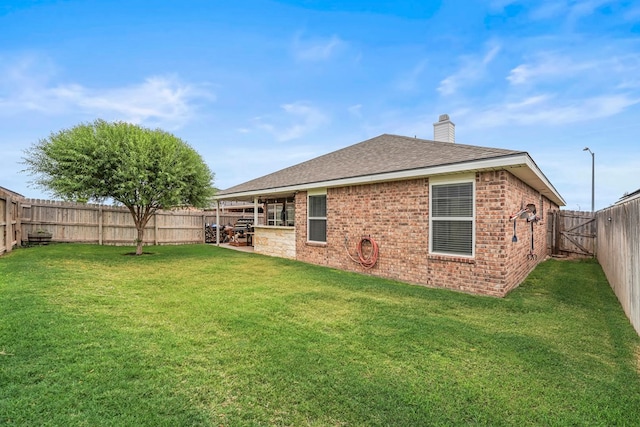 9910 Aloe Ct, Odessa, TX 79765 - back of house featuring a chimney, a fenced backyard, brick siding, and a shingled roof