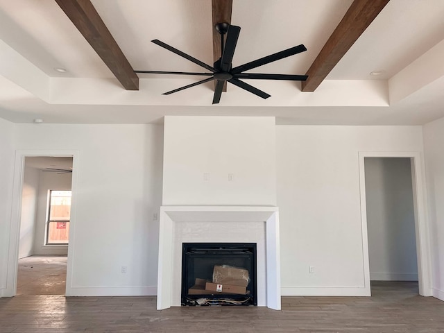 unfurnished living room featuring hardwood / wood-style floors, ceiling fan, and beamed ceiling