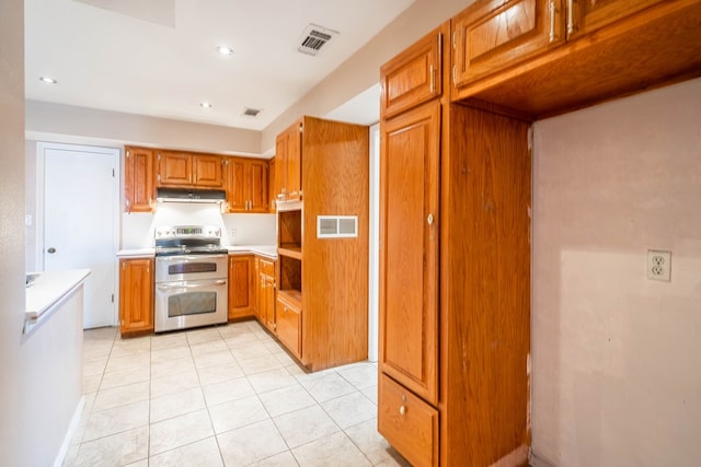 kitchen with light tile patterned flooring and range with two ovens