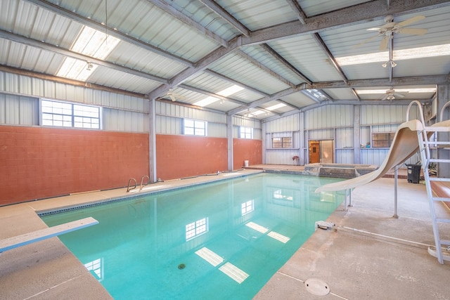 view of swimming pool with a diving board and a water slide
