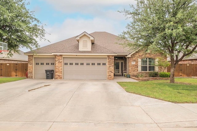 single story home featuring fence, a front lawn, driveway, and brick siding