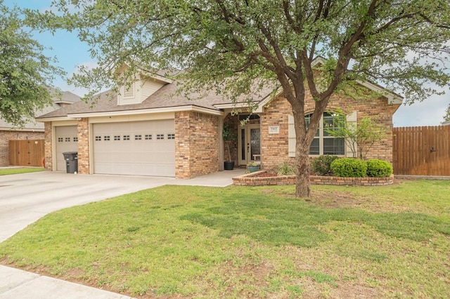 ranch-style home with driveway, an attached garage, fence, a front yard, and brick siding