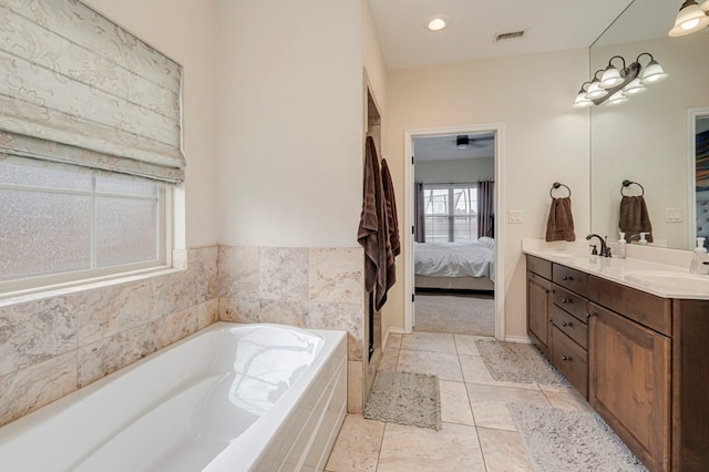 full bathroom with a sink, double vanity, ensuite bathroom, visible vents, and a garden tub