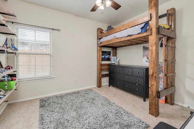 carpeted bedroom with a ceiling fan and baseboards