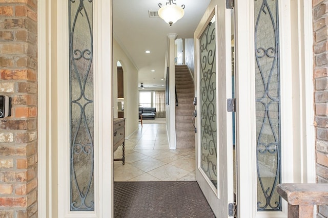 interior space featuring recessed lighting, stairway, visible vents, arched walkways, and light tile patterned flooring