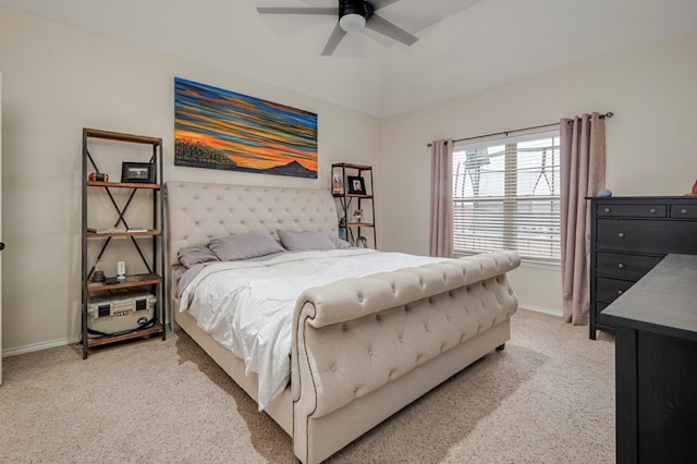 bedroom with a ceiling fan, baseboards, and light carpet