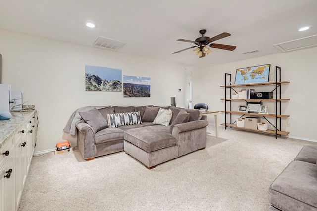 living room featuring ceiling fan, light carpet, visible vents, and baseboards