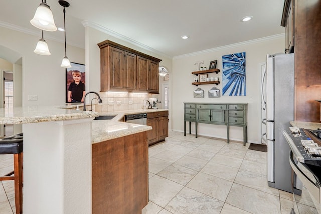 kitchen featuring decorative backsplash, a peninsula, light stone counters, and a sink