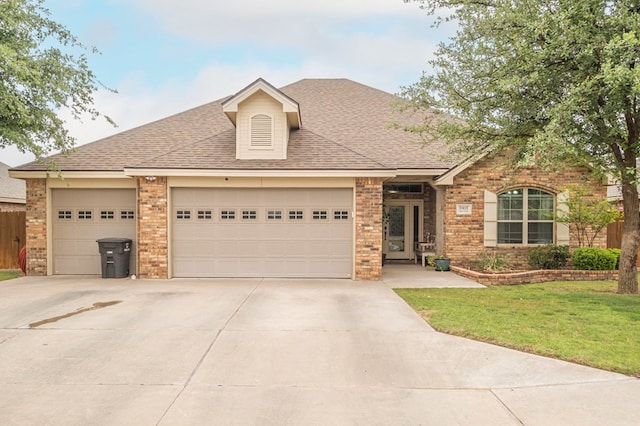 ranch-style home with a garage, driveway, and brick siding