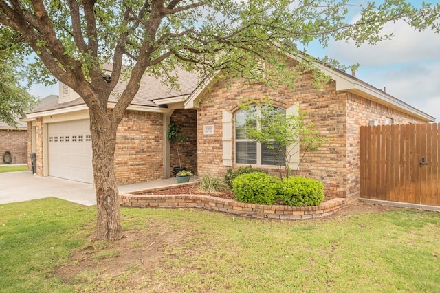 ranch-style house with concrete driveway, a front lawn, and brick siding
