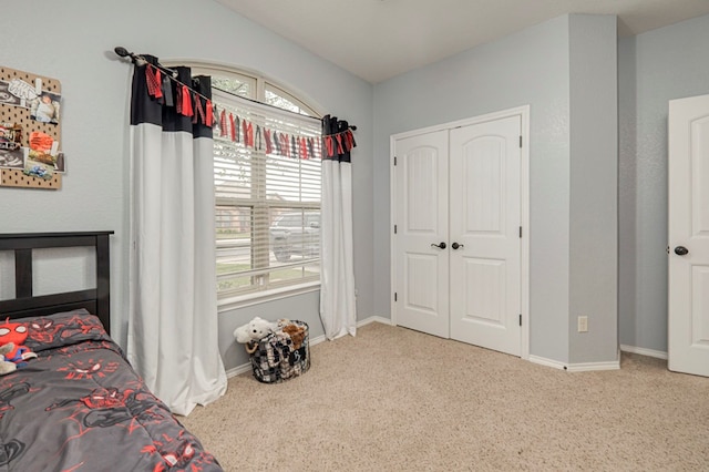 carpeted bedroom with baseboards