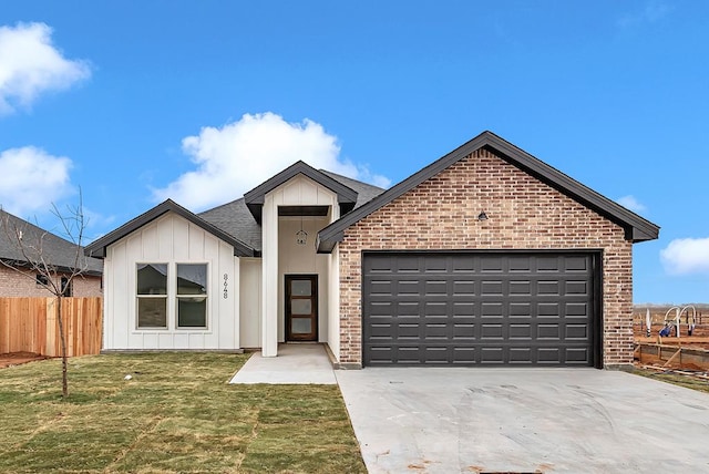 view of front of property with a garage and a front lawn