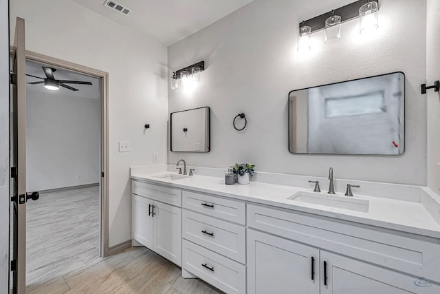 bathroom featuring ceiling fan, vanity, and wood-type flooring