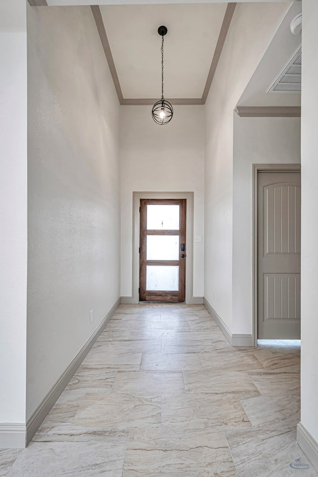 doorway to outside featuring crown molding