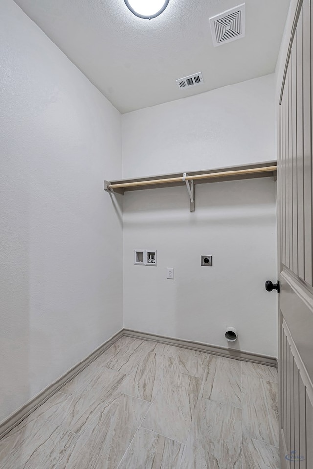 washroom featuring washer hookup, electric dryer hookup, and a textured ceiling