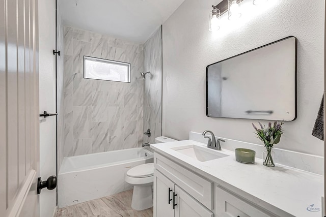 full bathroom featuring vanity, tiled shower / bath combo, toilet, and hardwood / wood-style flooring