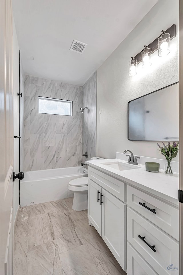 full bathroom with tiled shower / bath combo, vanity, and toilet