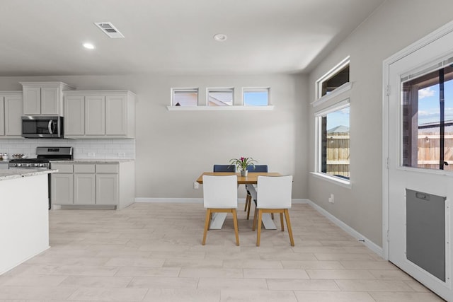 dining room with baseboards, visible vents, and recessed lighting