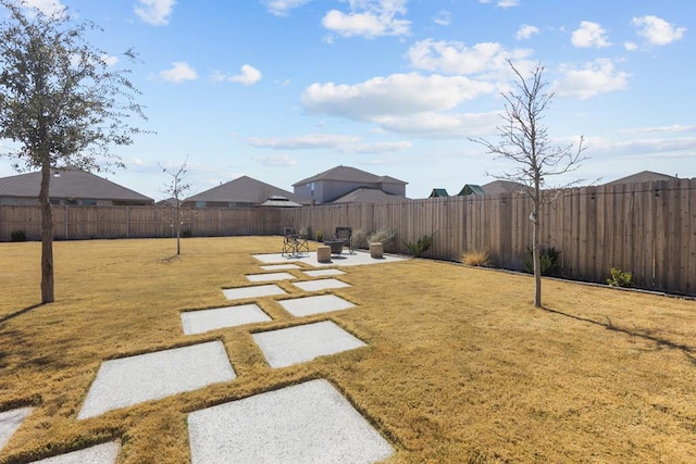 view of yard with a patio area and a fenced backyard